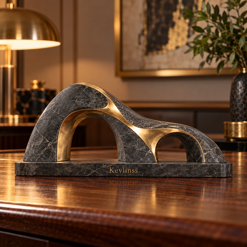 Dark marble-effect abstract arch sculpture with gold-tone curves