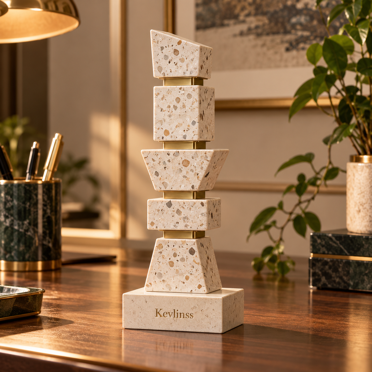 Vertical stacked geometric cream stone-look sculpture with gold-tone connectors