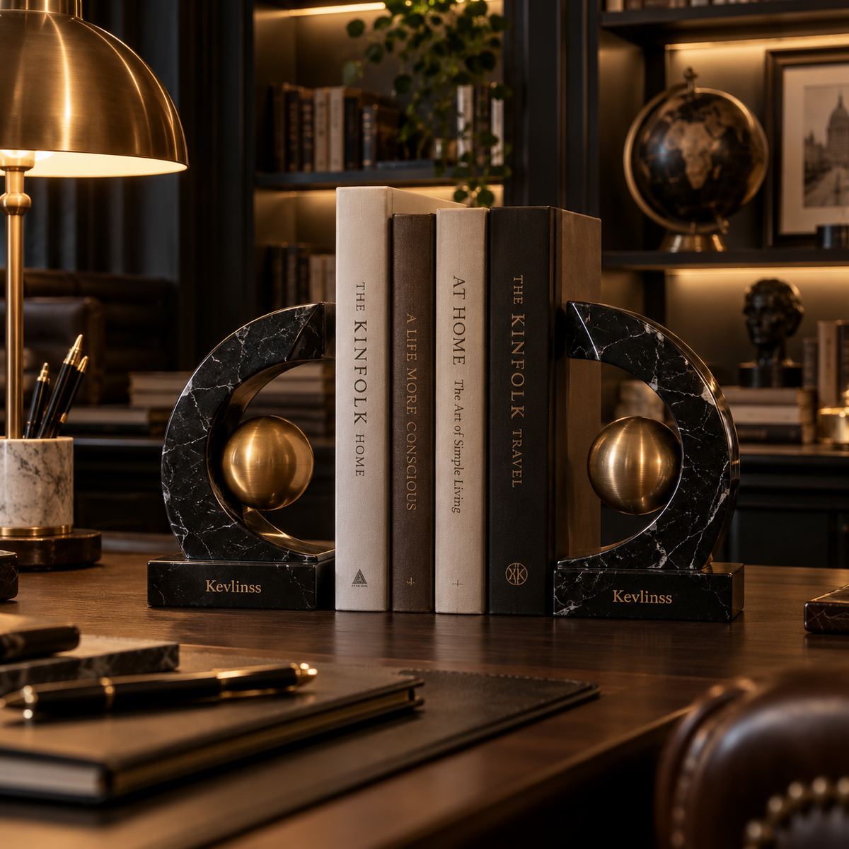 Dark marble-effect crescent bookends with gold-tone spherical details